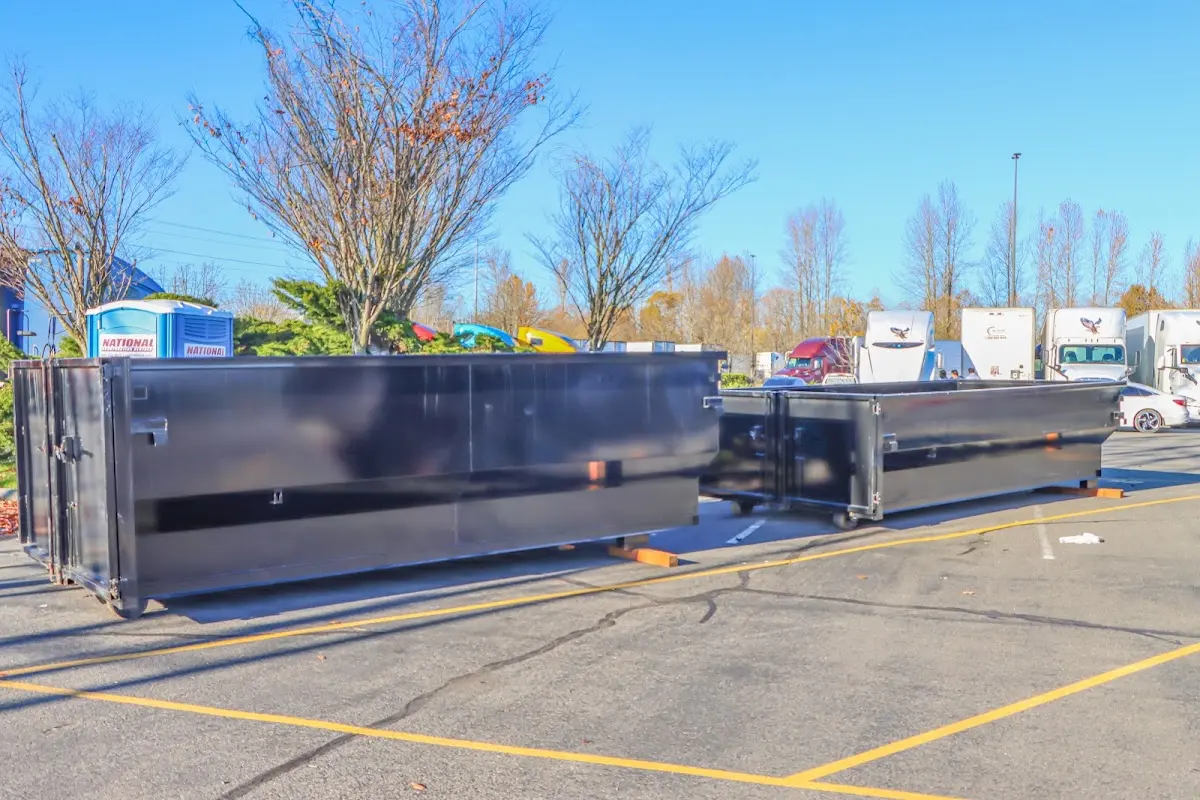 Professional dumpster rental service with roll-off container on residential driveway in East Rockhill